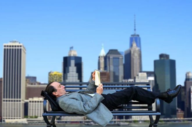 Businessman relaxing with a book