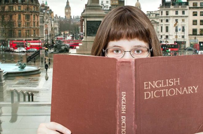 girl with spectacles looks over English Dictionary book and Trafalgar Square in London on background