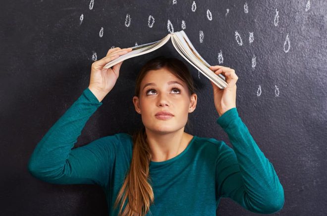 Cropped shot of an attractive young woman standing in front of a blackboard