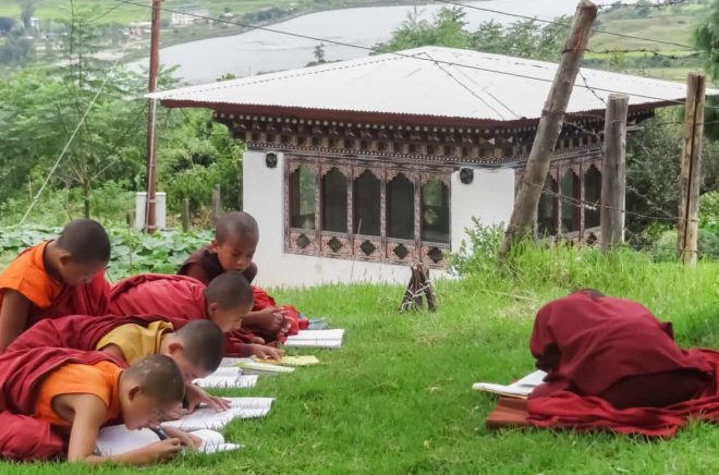 Paro,Bhutan,September 4,2013:Novices studying intently on the lawn in the temple